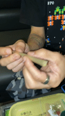 Person rolls cannabis joint in Barcelona apartment