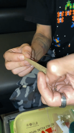 Person rolls cannabis joint in Barcelona apartment