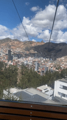 Cable car riders capture aerial views of La Paz cityscape
