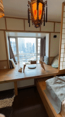 Interior room with wooden platform overlooks Yuzhong District skyline