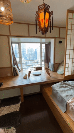 Interior room with wooden platform overlooks Yuzhong District skyline