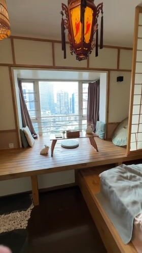 Interior room with wooden platform overlooks Yuzhong District skyline