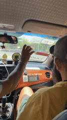 Taxi passenger gestures at windshield in Bắc Nha Trang