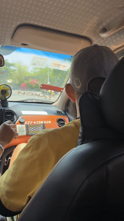 Taxi passenger gestures at windshield in Bắc Nha Trang