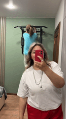 Woman Takes Mirror Selfie, Exercises at Home in Birobidzhan
