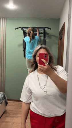 Woman Takes Mirror Selfie, Exercises at Home in Birobidzhan