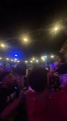 Nighttime outdoor party draws crowds in Lokoja, Nigeria
