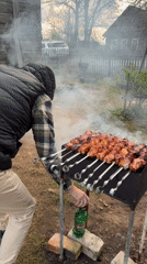 Man grills kebabs in backyard, Bronnitsy Russia