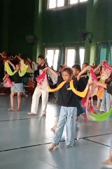 Dance rehearsal in a Demak community hall, traditional and casual styles
