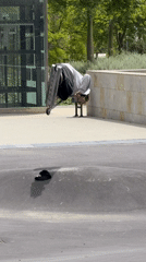 Scooter rider performs stunts on Barcelona plaza pump track