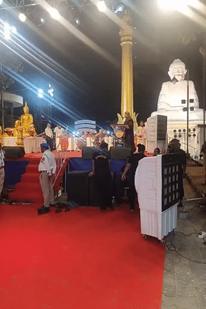 Illuminated outdoor ceremony staged in Mumbai with red carpet