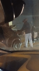 Evening street activity in Meknès with pedestrians and parked car