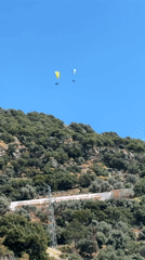 Two paragliders spotted over Fethiye, Turkey hillside