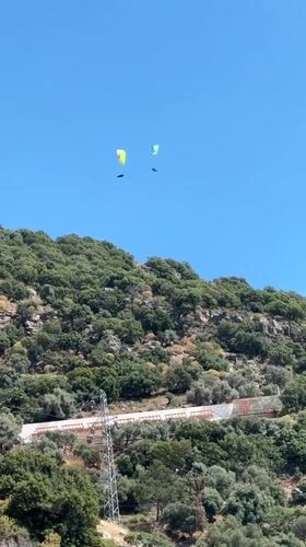 Two paragliders spotted over Fethiye, Turkey hillside