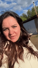 Woman documents garage area visit in Noviy, Russia