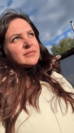 Woman documents garage area visit in Noviy, Russia