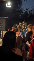 Two men embrace at outdoor gathering in Krasnoyarsk