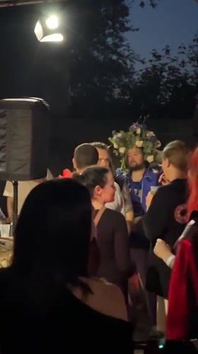 Two men embrace at outdoor gathering in Krasnoyarsk