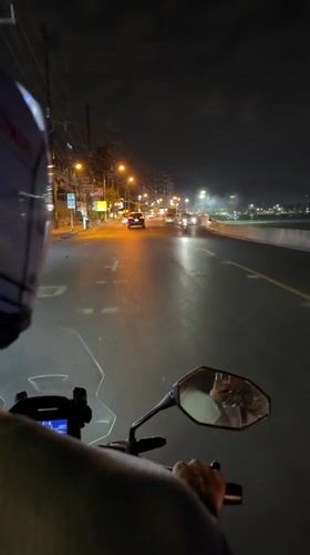 Motorcycle rider documented traveling through Patong, Thailand at night