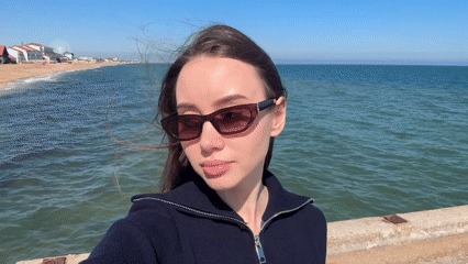 Woman takes selfie on Ukrainian pier during sunny day