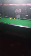 Men play pool at night recreation venue in Lokoja