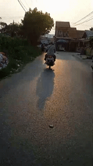 Morning activity around a Banjarmasin neighborhood street and generator