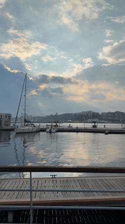 Sailboat docked at Nessebar waterfront under partly cloudy skies