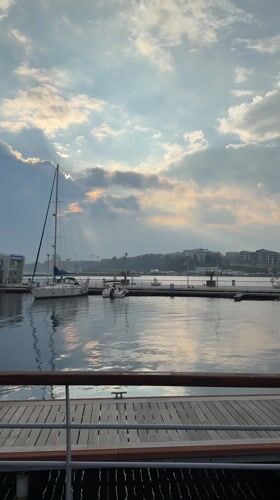 Sailboat docked at Nessebar waterfront under partly cloudy skies