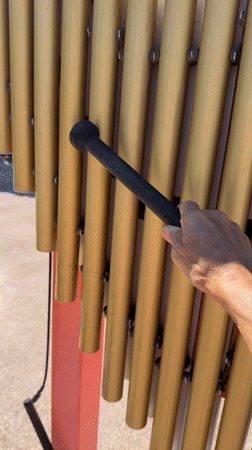 Playing with outdoor musical instruments and interactive gear panels in Irvine