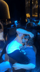 Nightclub scene with patrons socializing and live performance