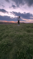 Person watches sunset over Shumen from hillside vantage point