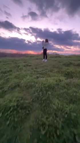 Person watches sunset over Shumen from hillside vantage point