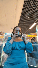 Woman drinks from silver cup in Izhevsk commercial space
