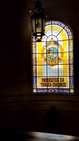 Woman tours Universidad Católica de Chile campus buildings