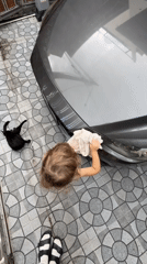 Toddler washes car and motorcycle at Choeng Thale home