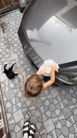 Toddler washes car and motorcycle at Choeng Thale home