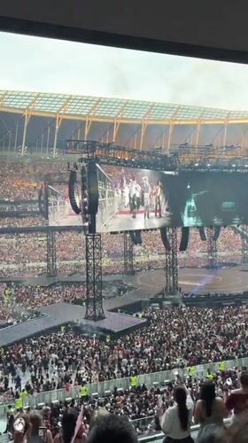 Packed London stadium concert, multiple angles from the crowd