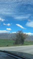 Vehicle travels scenic Bulgarian road with mountain backdrop