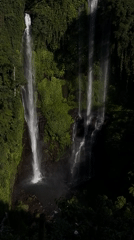 Multi-tiered jungle waterfall in Sawan, Indonesia, from above and below