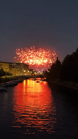 Fireworks light up a city waterfront at night