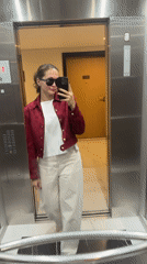 Woman in red jacket moves through Dubai building locations