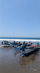 Fishing boats and crews at work on Desa Pagandaran beach