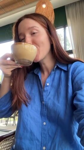 Woman enjoys morning coffee, takes selfies at Thai cafe