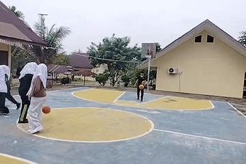 Students play basketball at a school court in Purwodadi