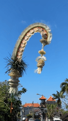 Bali street life: traffic, café, trinkets, and ceremonial décor
