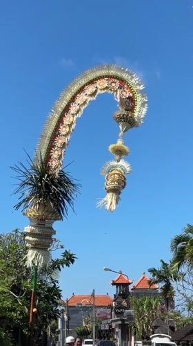 Bali street life: traffic, café, trinkets, and ceremonial décor