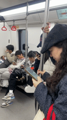 Chongqing subway passengers engage in typical commute activities