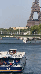 Boats on the Seine with the Eiffel Tower on a sunny afternoon