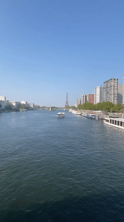 Boats on the Seine with the Eiffel Tower on a sunny afternoon