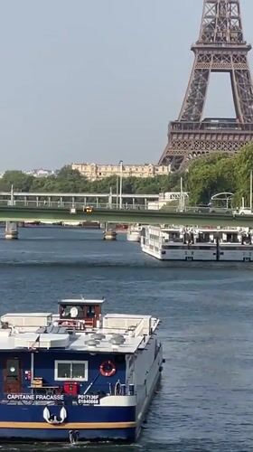 Boats on the Seine with the Eiffel Tower on a sunny afternoon
